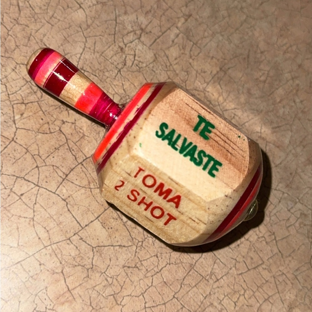 “ Adult Pirinola “Wooden Spinning Top with Red and Green Text
